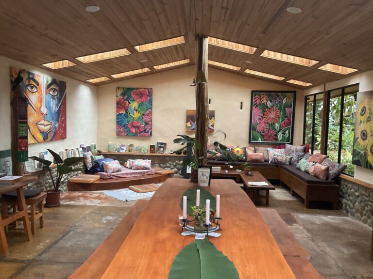 Long communal wooden table in the open dining hall where farm-to-table meals are shared, Costa Rica