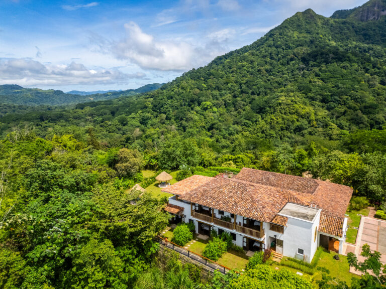 The hacienda seen from the air against the forested mountains of Mastatal, Costa Rica