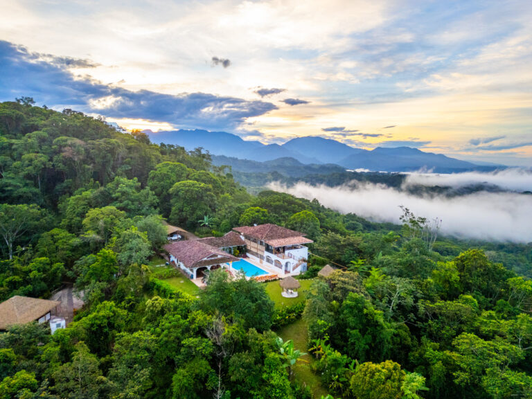 Aerial view of Hacienda Las Vainillas at sunset with mist rolling over the rainforest, Costa Rica