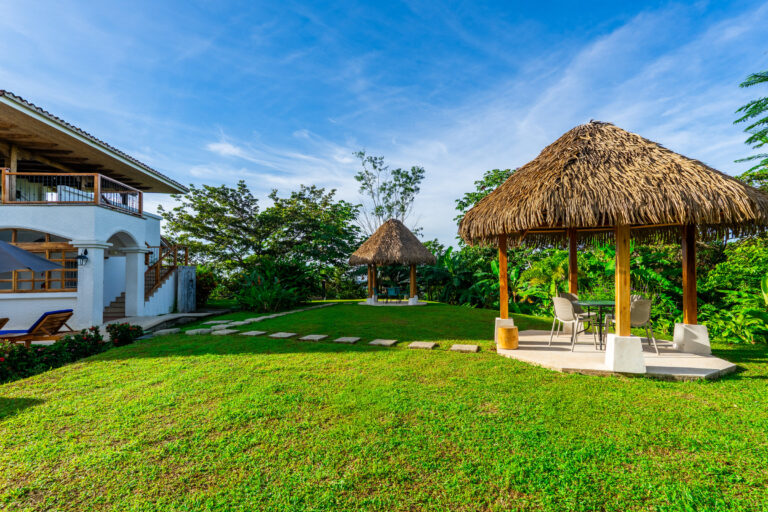 Lawn and thatched rancho in front of the hacienda, a spot for outdoor yoga, Costa Rica