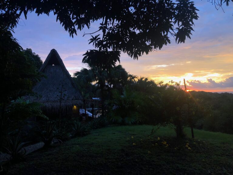 Thatched rancho and garden at sunset, Calamocha Lodge, Costa Rica