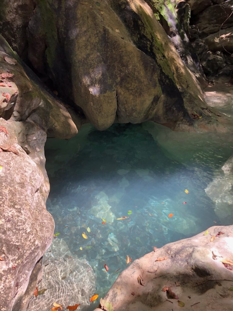 Turquoise natural pool carved in the rock along a jungle river, Costa Rica