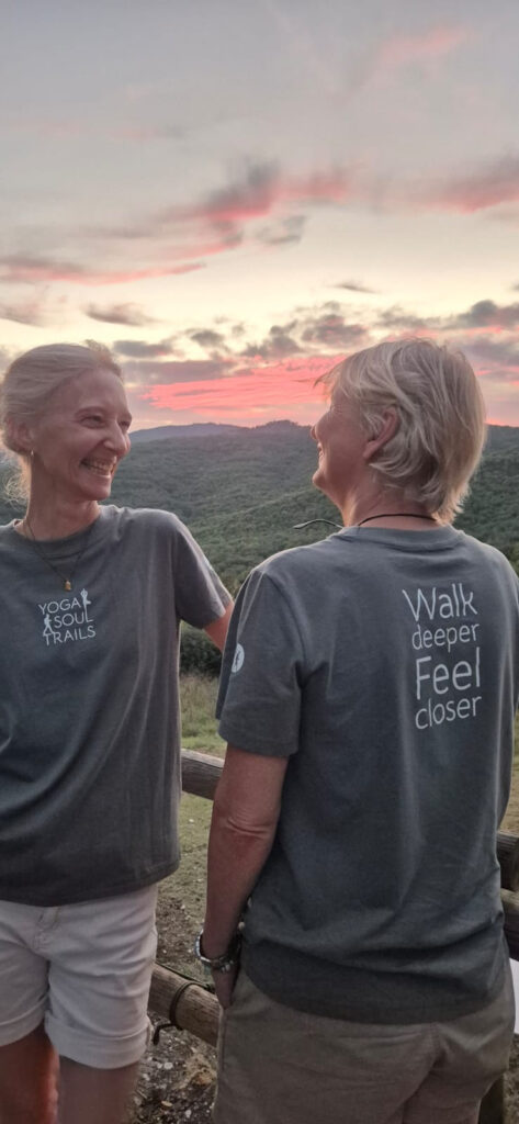 Antoinette and Isabelle laughing together at sunset above the green hills of Costa Rica