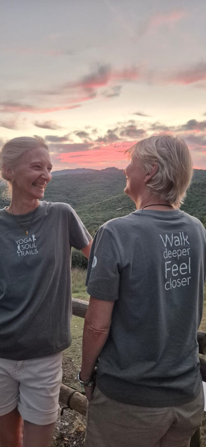 Antoinette and Isabelle laughing together at sunset above the green hills of Costa Rica